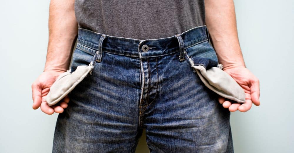man turning out his empty jeans pockets