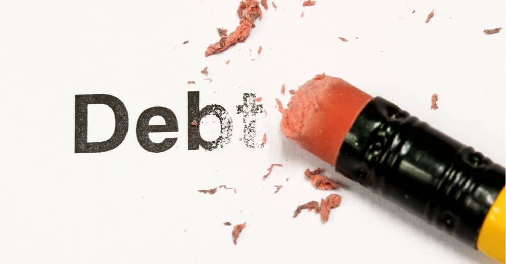pencil erasing the word debt