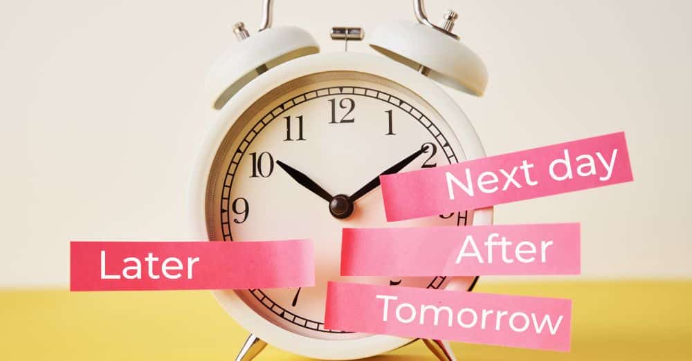 alarm clock with words later, next day, after, and tomorrow in pink