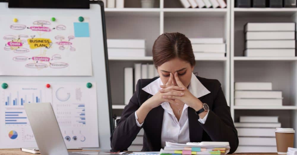 business professional stressed head in hands