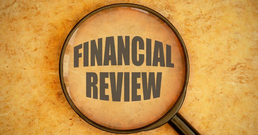 financial review with magnifying glass